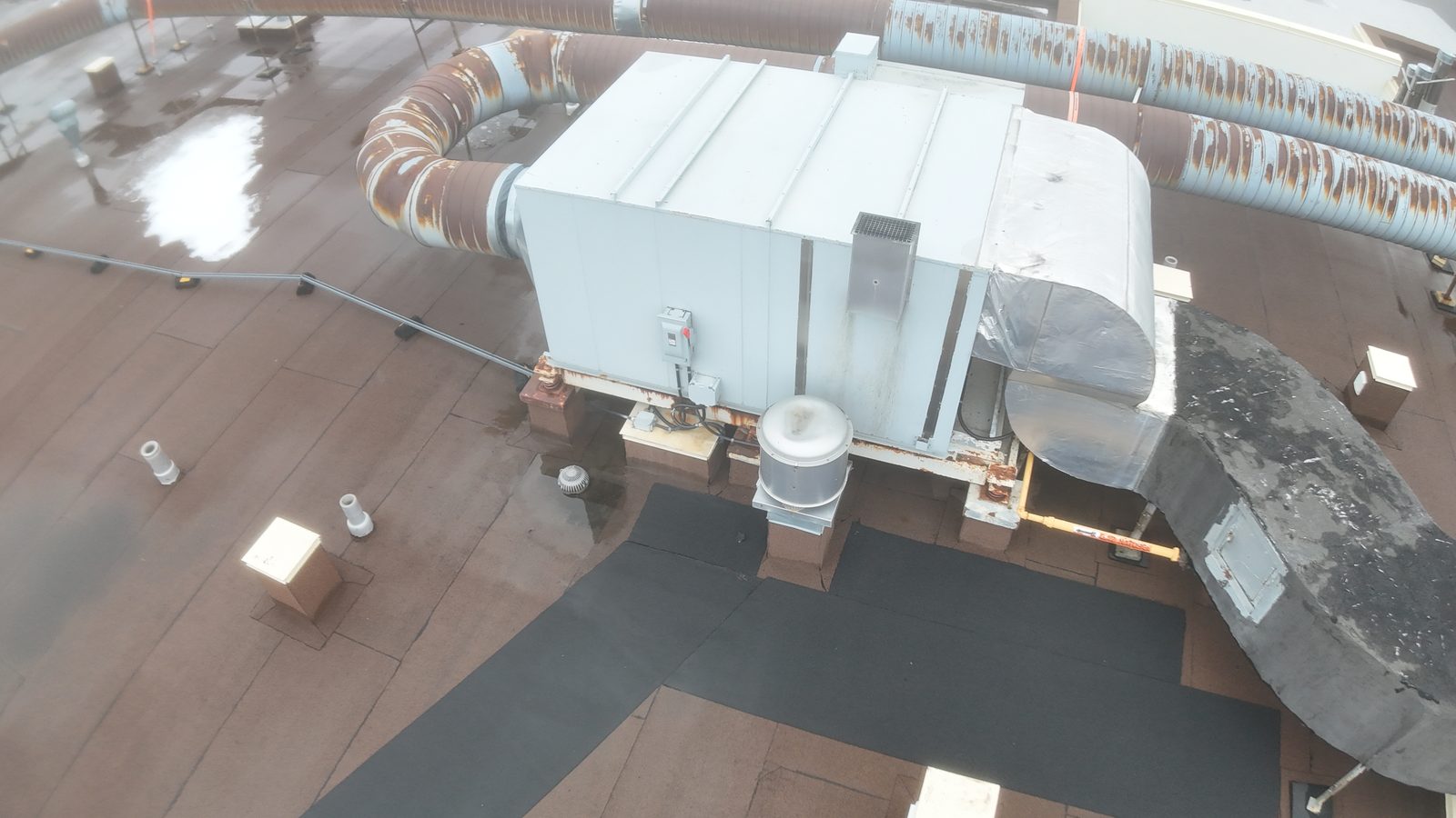 Rooftop mechanical units and ducts on a commercial flat roof